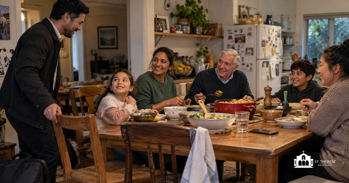 A warm and welcoming scene unfolds around a large wooden dining table in a modest, lived-in family home. Six people of different ages and backgrounds are gathered for an informal evening meal, sharing food, conversation and genuine smiles. The atmosphere is relaxed and affectionate, capturing an ordinary moment of human connection, belonging and acceptance.